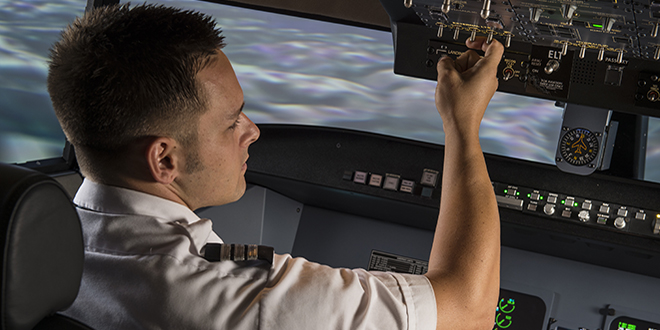 aviation student uses flight simulator