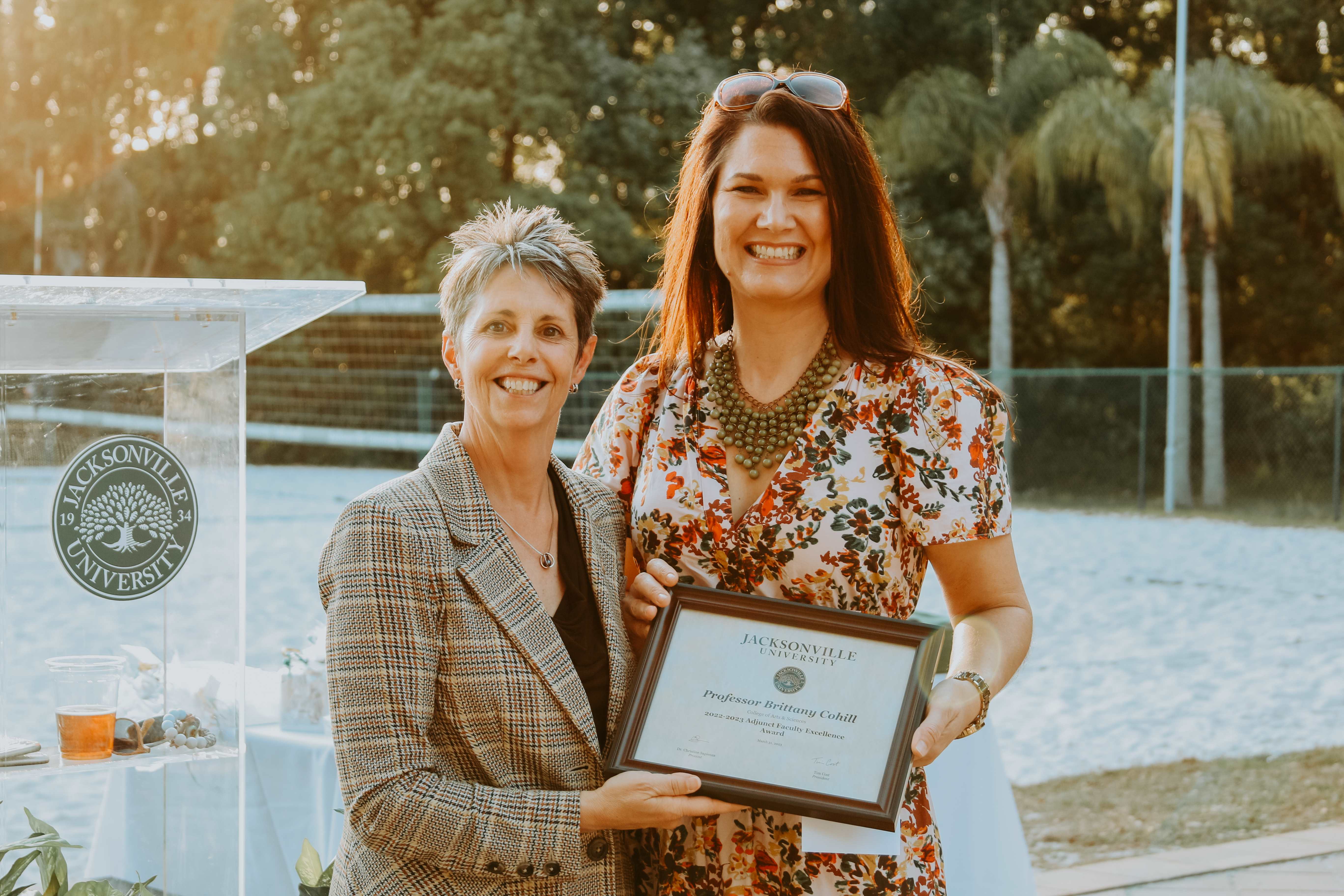 two women holding an award