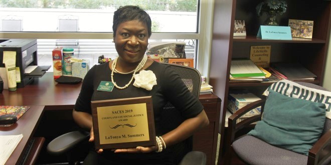 Dr. Summers posing with her award plaque.