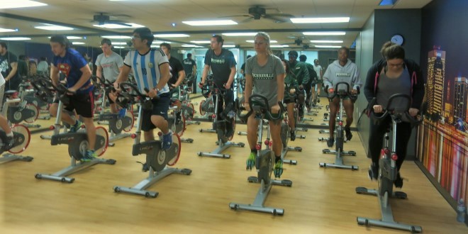 students participate in cycling class