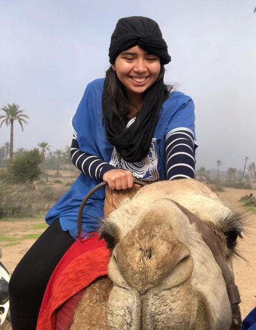 Emilia taking a camel ride