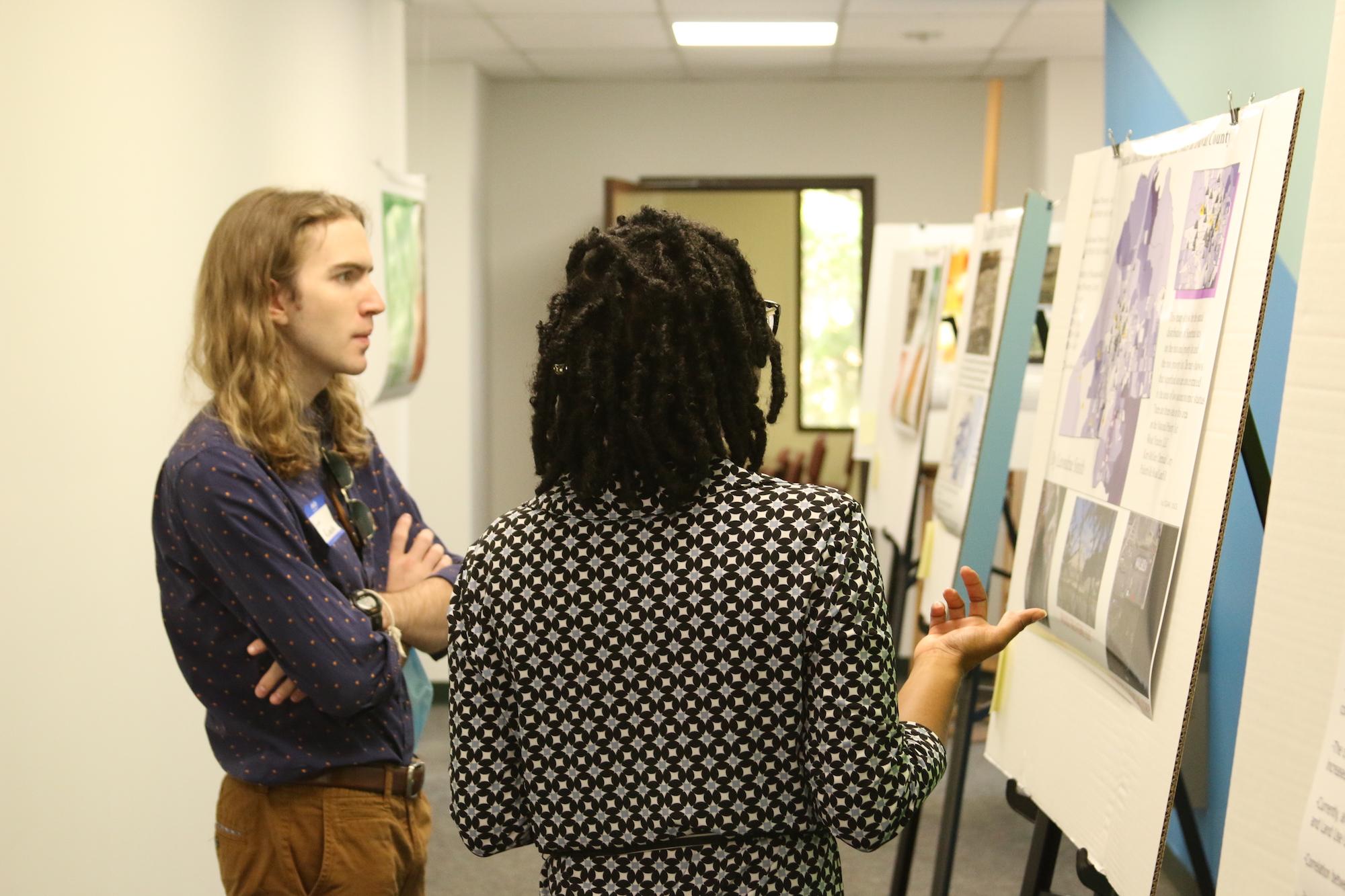 Caucasian male and African American female student discussing a map