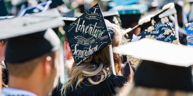Focused photo on a grad cap on the head of a female JU student that reads 