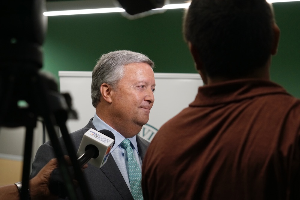Tim Cost speaks with the media