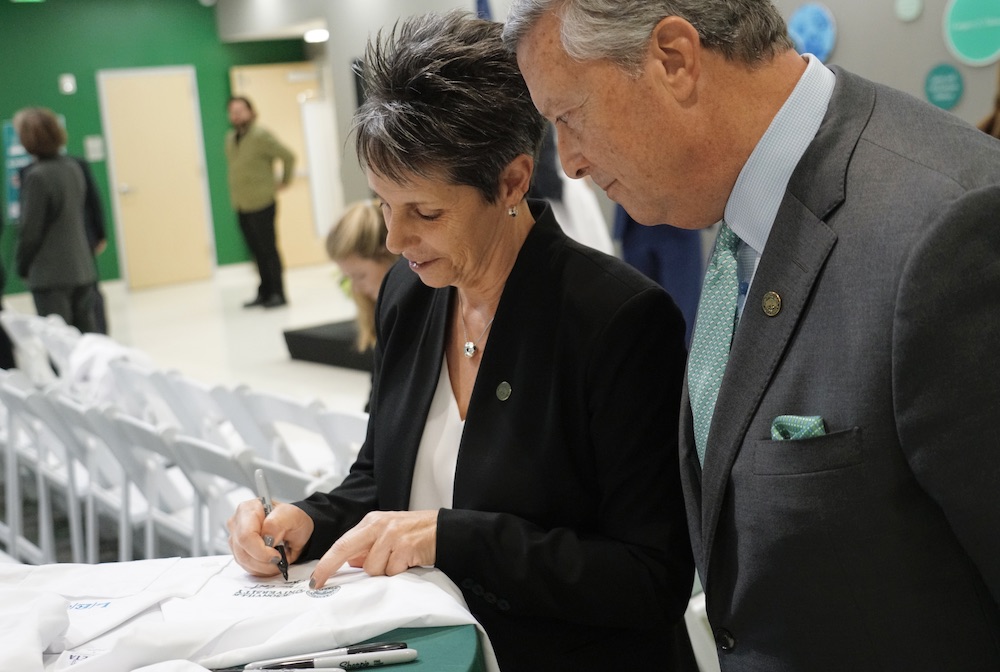 Provost Sapienza signs the commemorative white coat