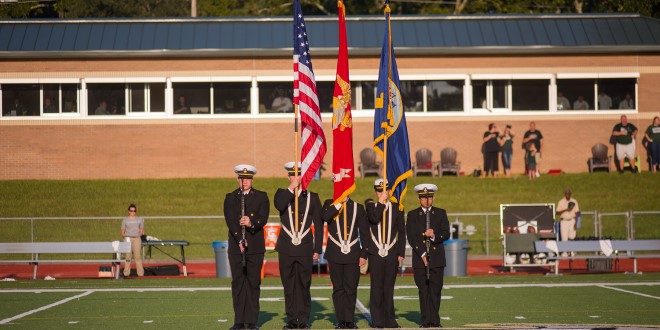 Students with flags from JU's NROTC unit. 