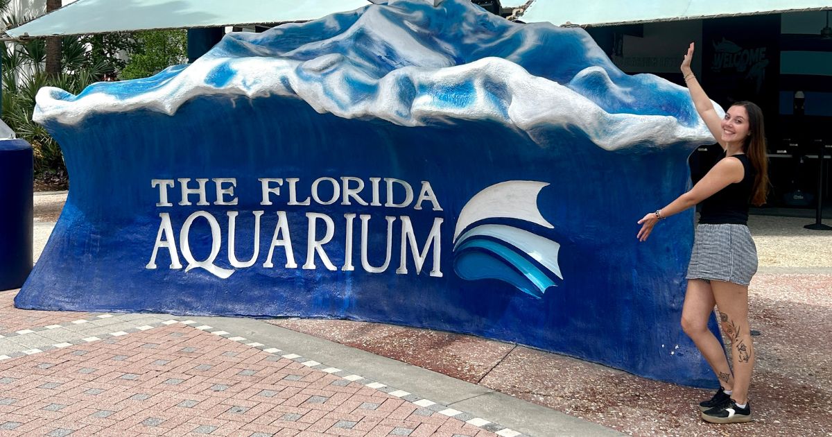 Natalie Holden standing at the entrance of the Florida Aquarium