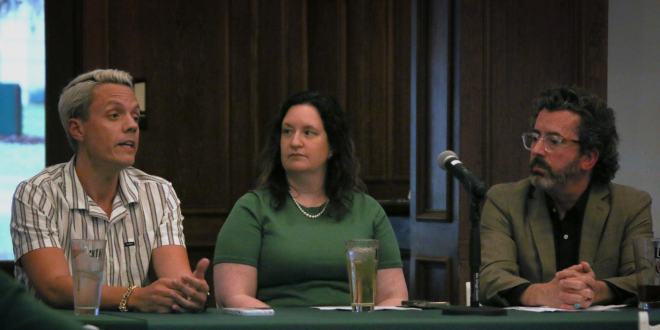 three people talking at a table