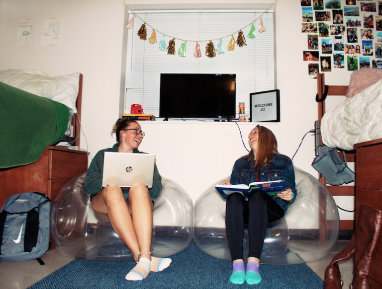 Two girls hanging out in their dorm together