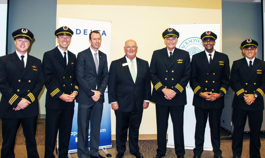 Capt. Matt Tuohy (center), Director of the JU School of Aviation, stands with Jim Graham (right of Tuohy), Delta’s Senior Vice President of Flight Operations, and the rest of the Delta Propel team.