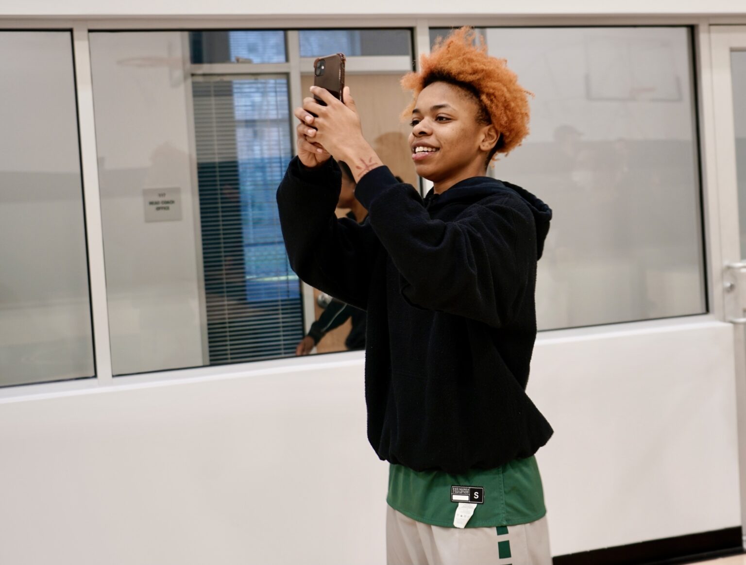 women's basketball player takes photos of the basketball performance center