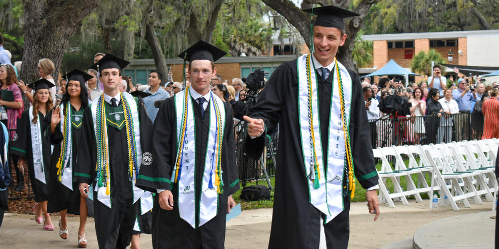 Graduates approaching the stage to receive their degrees