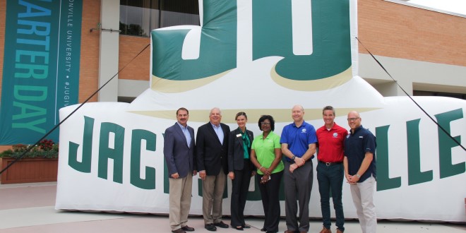 group poses in front of JU inflatable