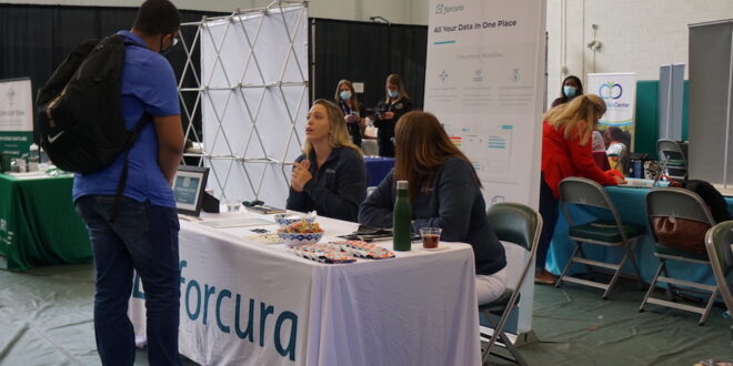 forcura speaks to student at career fair