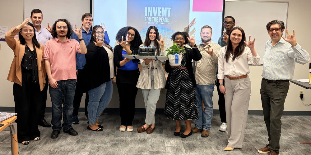 JU computer science students stand with their prototype for the IFTP Hackathon.