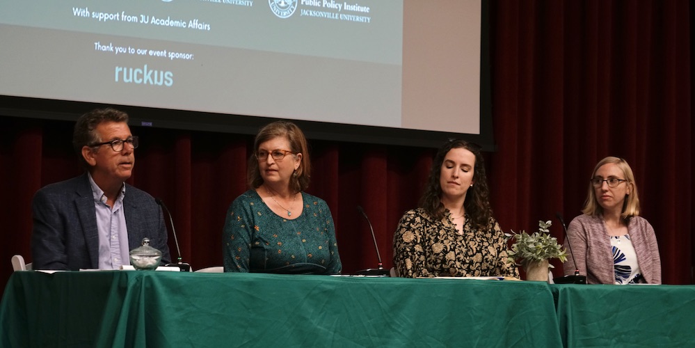 Four experts sitting at a panel 