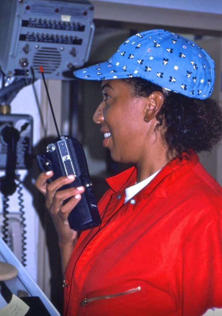 Dawn Wright speaking into a walkie talkie radio.