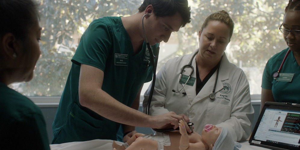 nursing students practice on mannequin infant