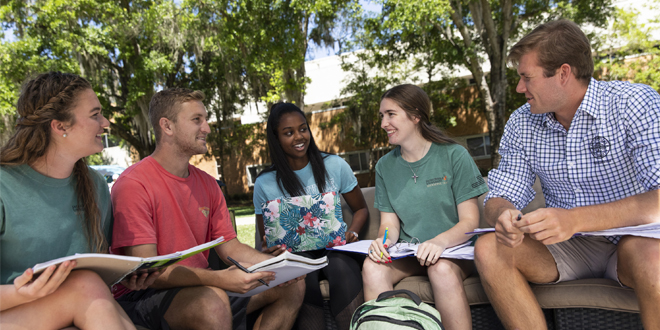 five students studying outside 