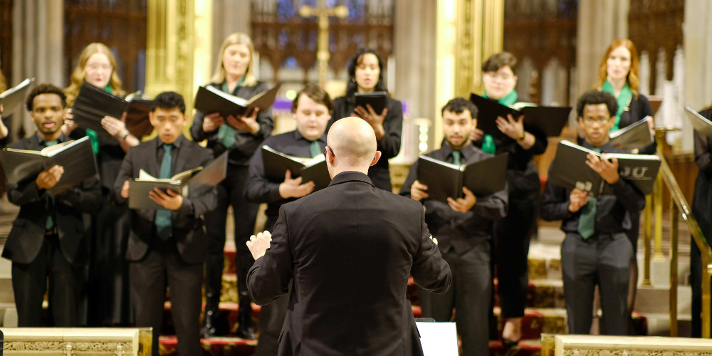 Conductor in front of a choir at a cathedral 