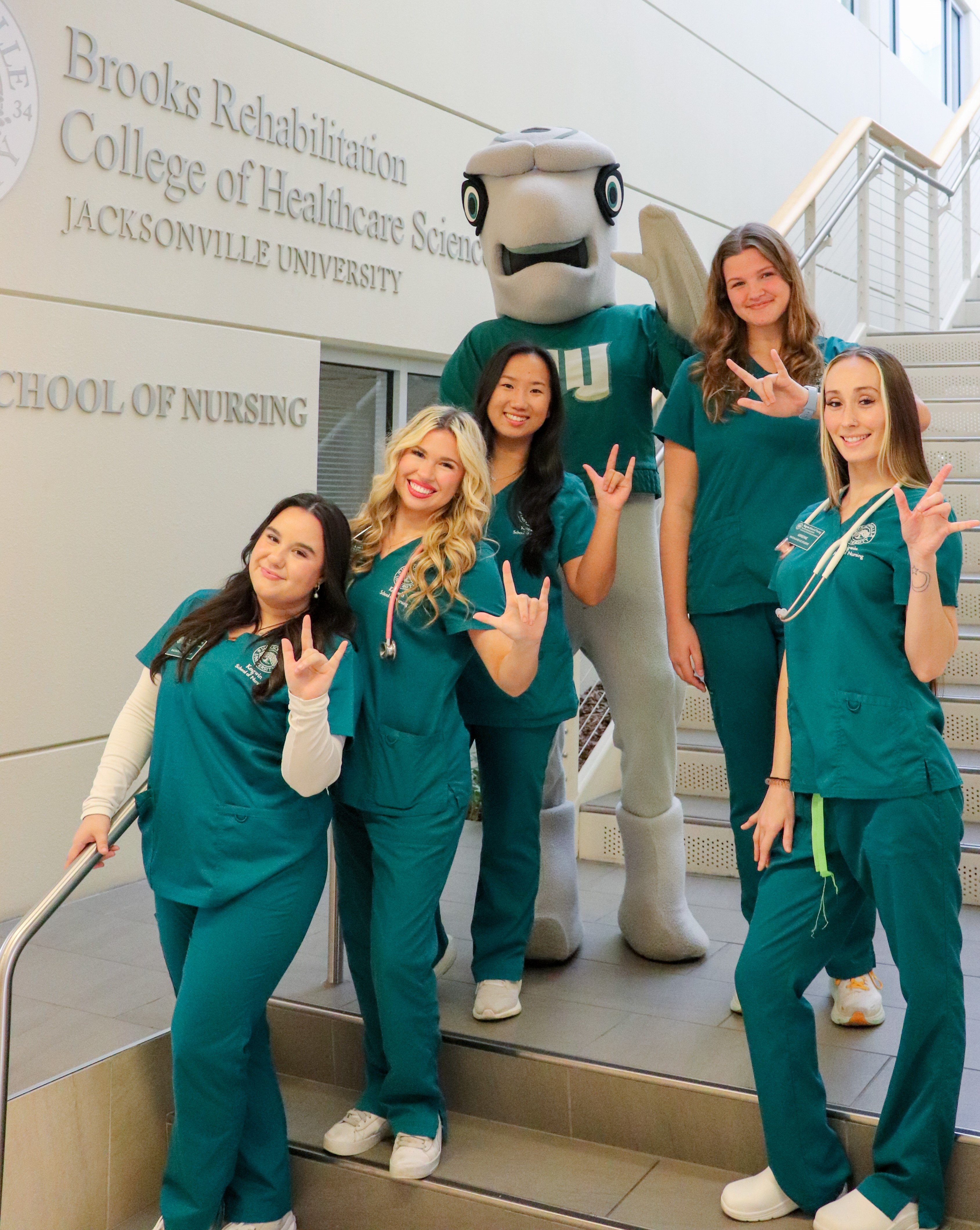 Students on stairs with mascot