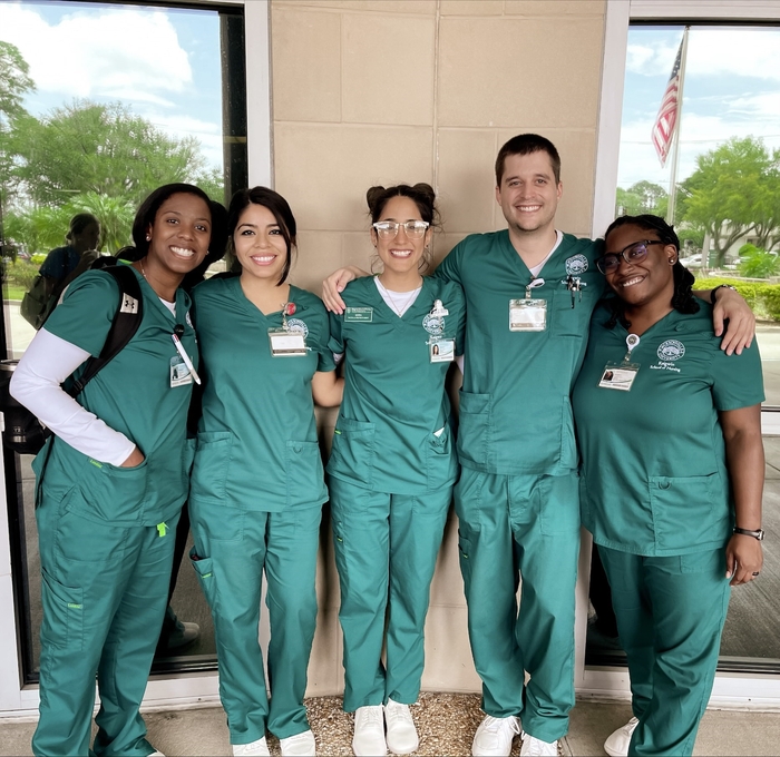 Nursing students stand together smiling