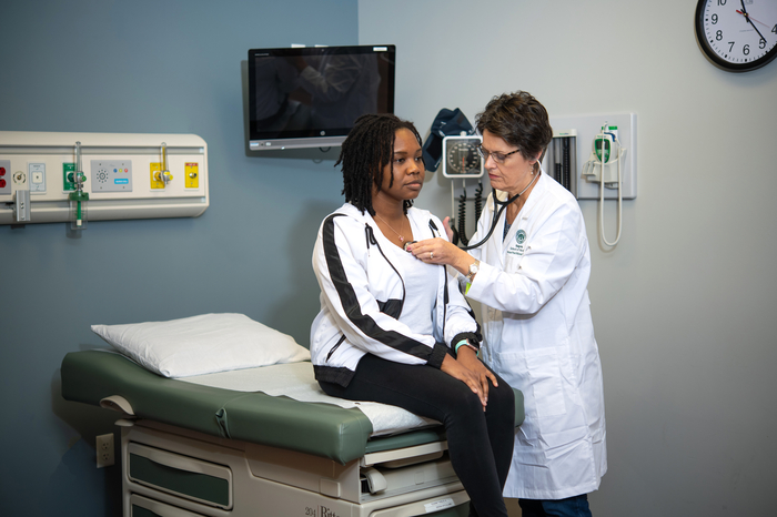 Nursing students taking care of a patient.