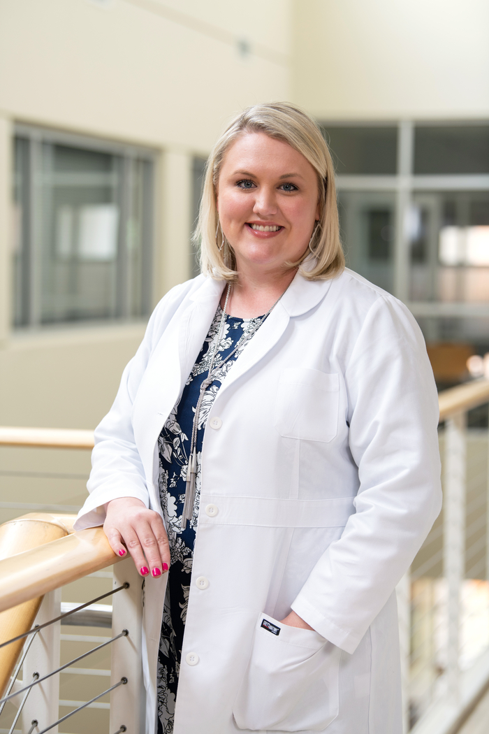 A nursing student smiles for a photo.