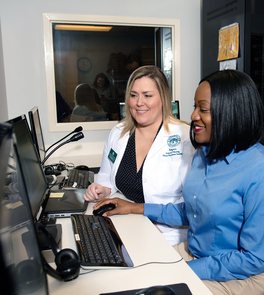 A team of healthcare professionals working on the computer.