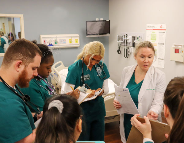 Jacksonville University professor debriefing nursing students before simulation