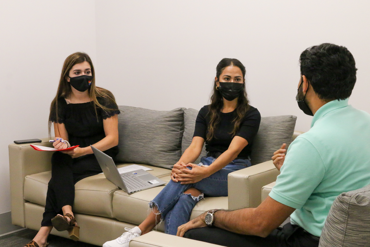 Three graduate students in discussion group in a clinical mental health counseling room