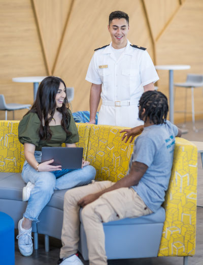 Three students gathered together in conversation at Kinne Center