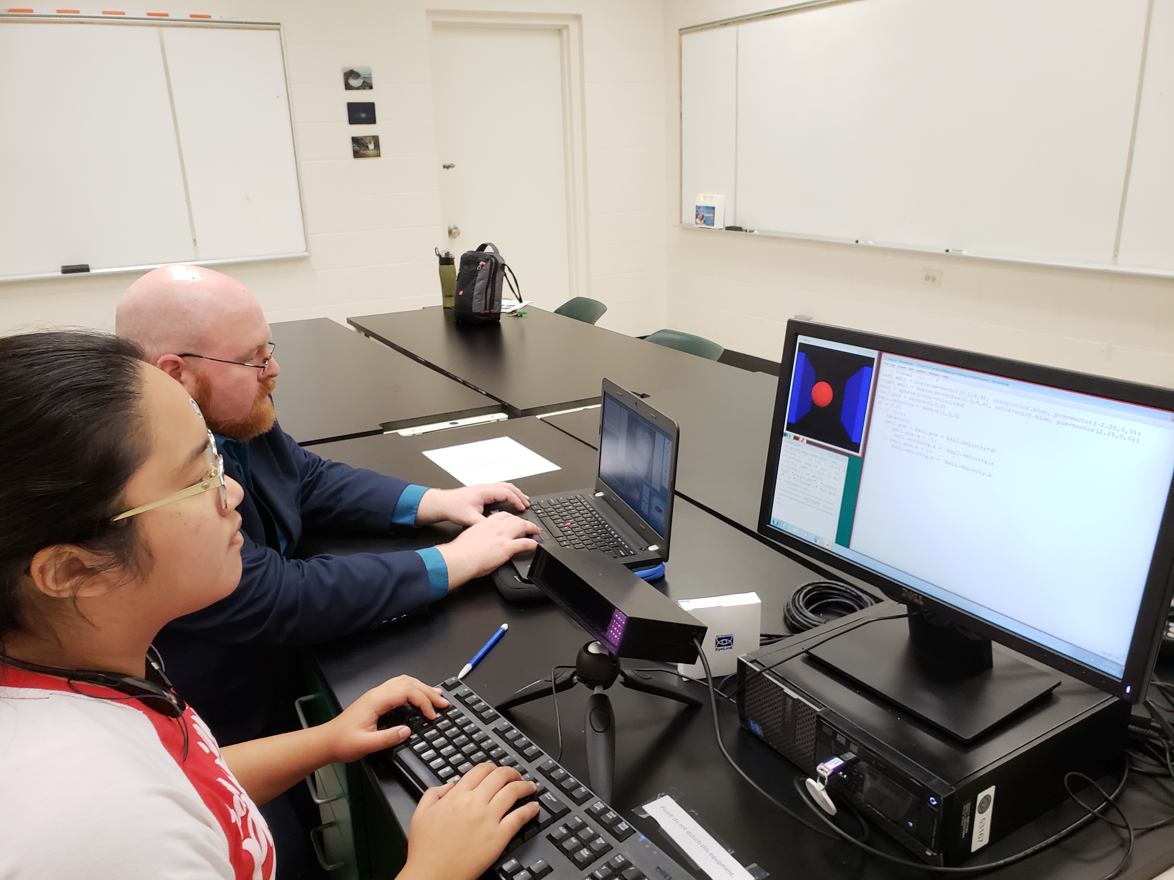 Daniel Furnas with student using eye tracking on computer