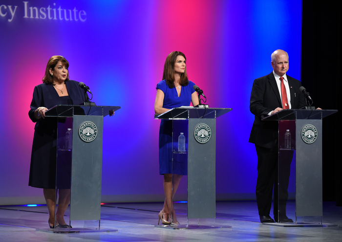 State Attorney's Debate with two women and one man debating on stage.