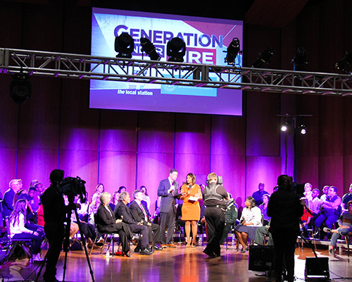 A televised forum with a town-hall-style crowd gathered on stage.