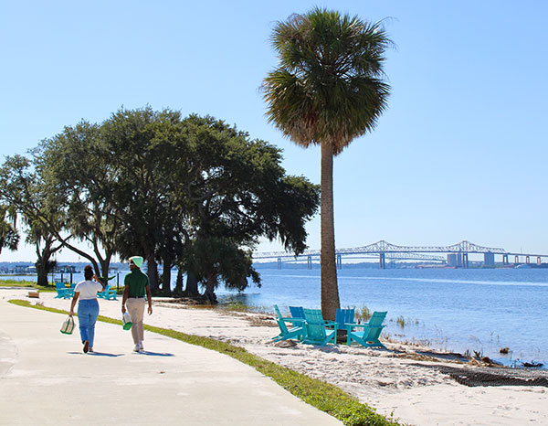 Students walk along the St. Johns riverbank.