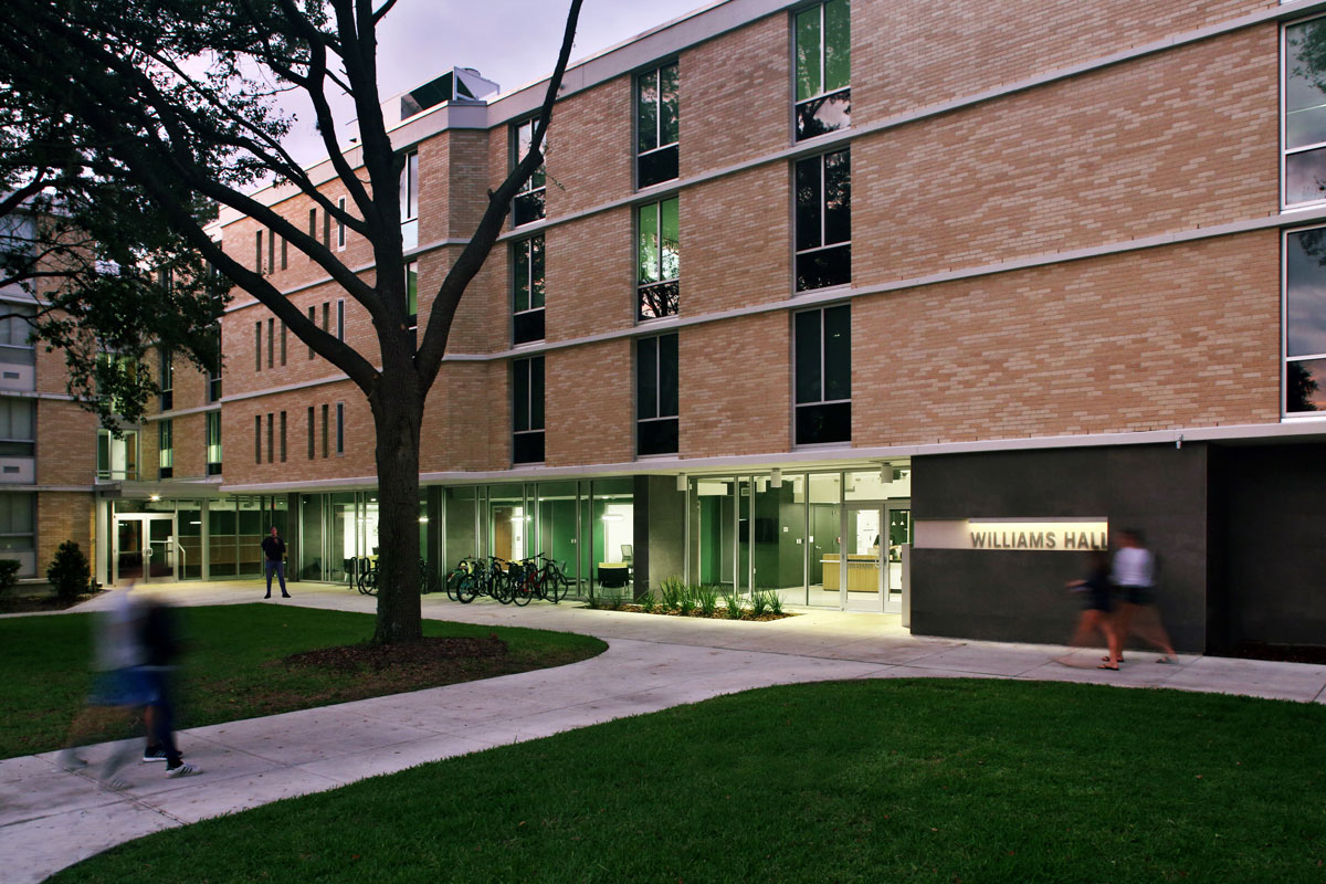 Exterior of Williams Hall in the evening with lobby lit up