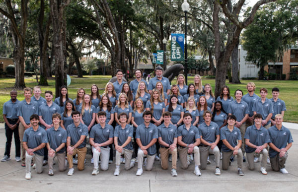 JU Sailing Team posing for a group photo behind Howard Administration Building by the Dolphin Status