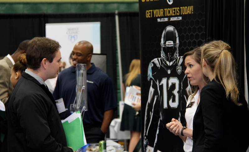 People at an events table selling tickets. 