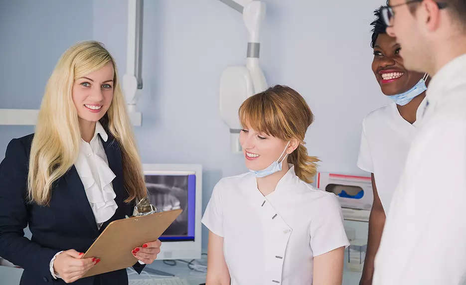 Dental office manager consults with the doctor and nurses