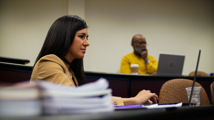 Businesswoman taking notes during class