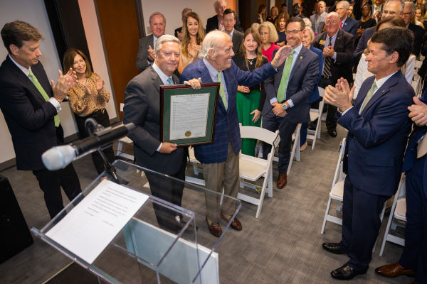 Tim Cost, President of Jacksonville University, honoring Preston Haskell, founder and former chair of The Haskell Company.