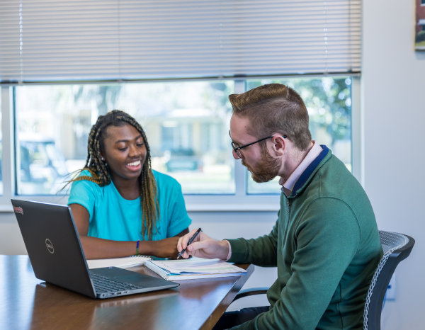 The dolphin statues behind Howard Administration Building.